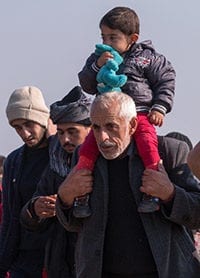 Photo of refugees walking.