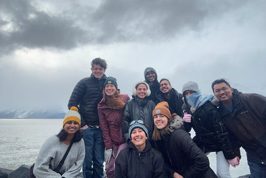 Large group of people posing outdoors in cold weather wearing warm clothing