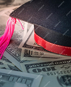 Graduation cap resting on dollar bills