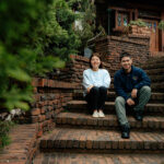 Mona Tao and Roger Huang sitting outside on some brick steps