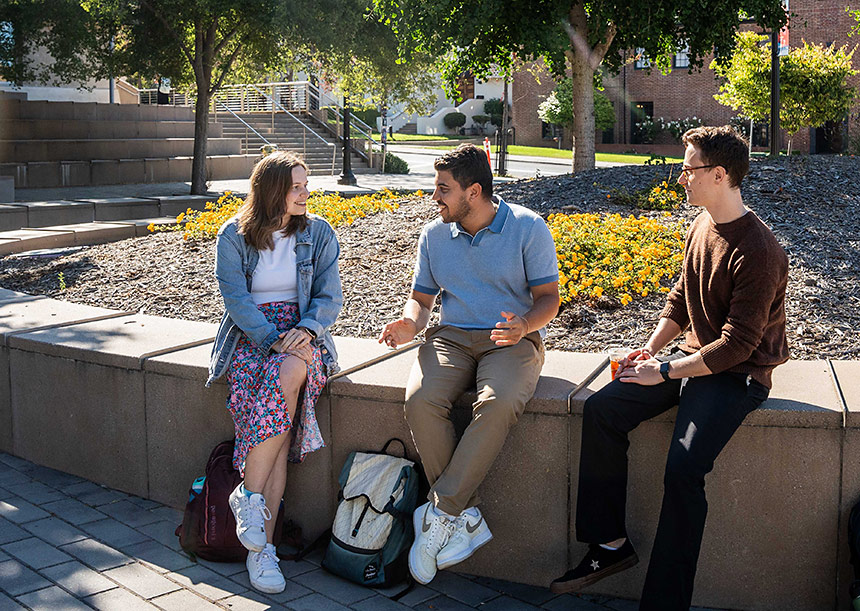 Three students sitting outside