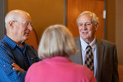 Former Alaska Supreme Court Chief Justice Daniel Winfree '81 (right) chats with Richard Rosston '77 and Susan Miller '73. Photo by Nathaniel Wilder