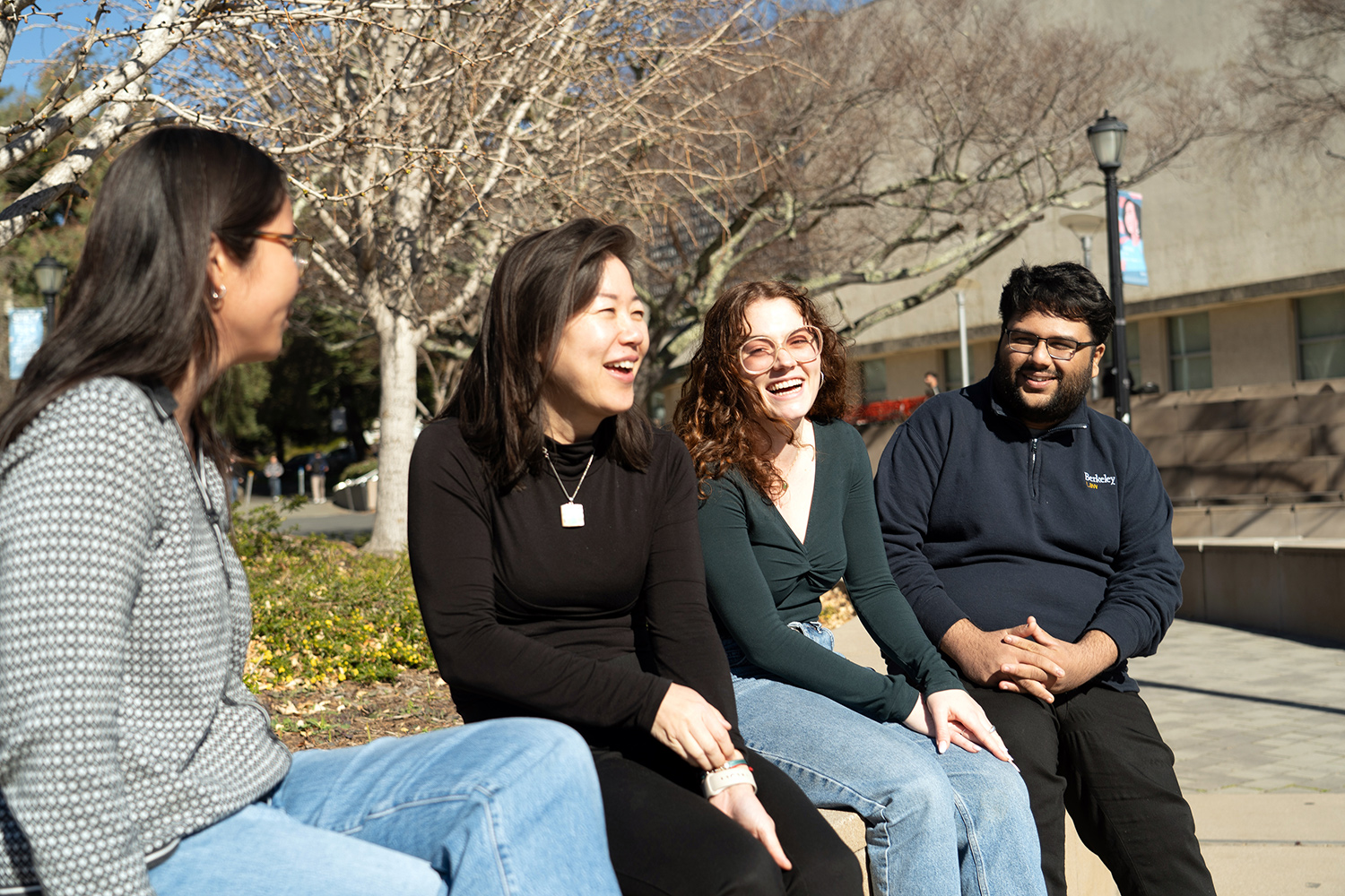 Colleen Chien sitting outside laughing with students